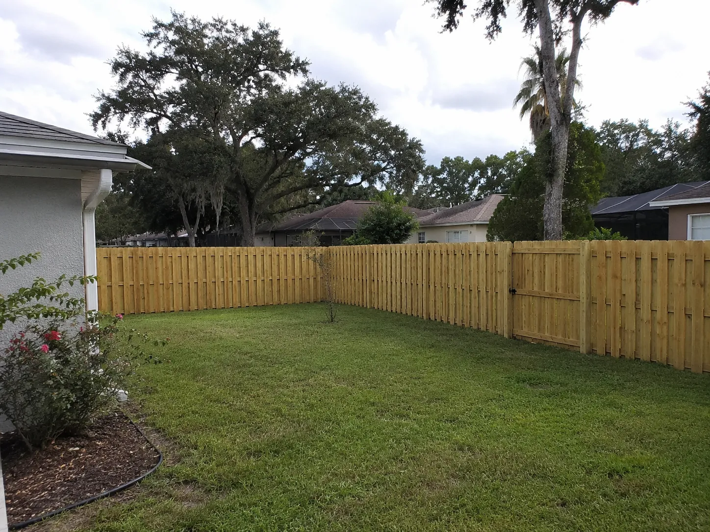Wood privacy fence installation around a Jacksonville Florida backyard