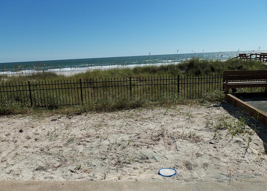 Metal Fence Along The Beach Views