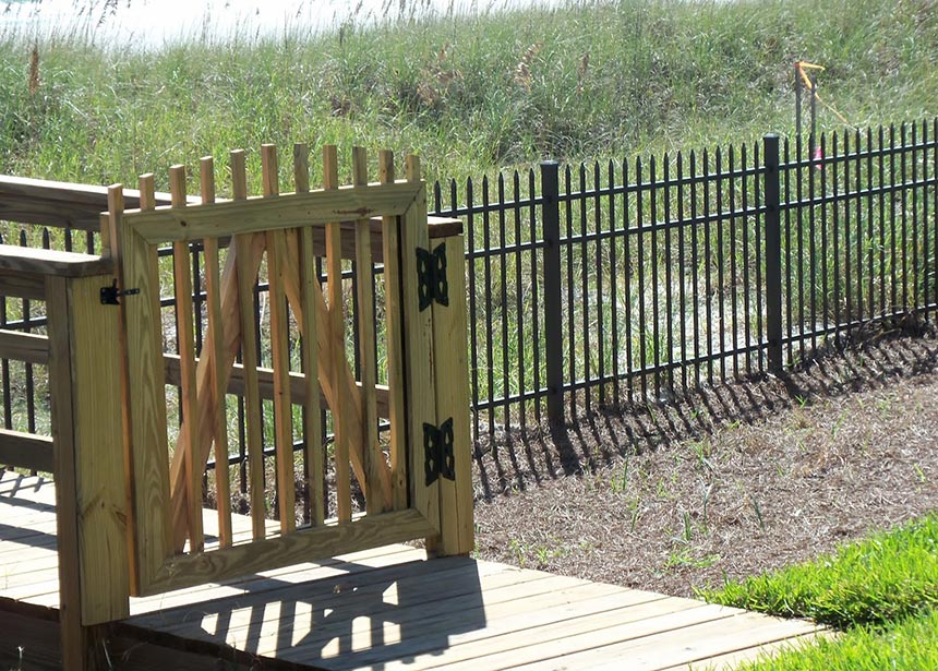 Metal Fence Along The Beach With Walkover Gate Closeup