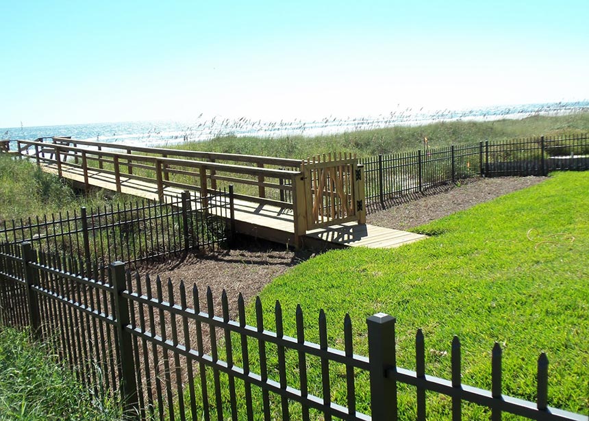 Metal Fence Along The Beach With Walkover Gate