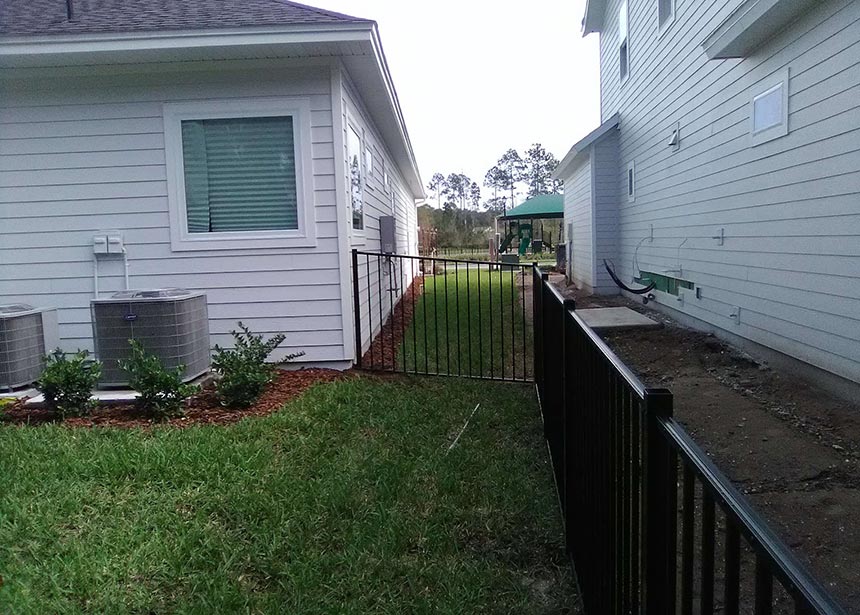 Short Fence For Dogs Along Sloped Yard