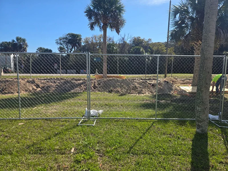 Temporary chain link fencing installed around a secured work area