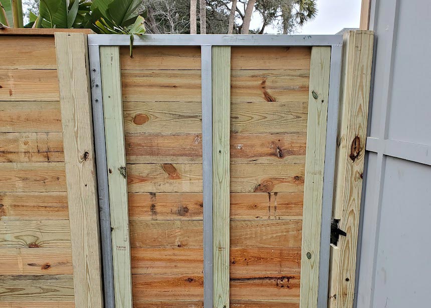 Wood Fence Around Pool Gate Reinforced With Metal